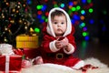 Kid Santa Claus near Christmas tree with gifts Royalty Free Stock Photo