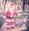 A kid in Santaclaus suit push reindeer doll away , unfriend conc