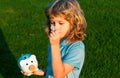 Kid saving coin money with piggy bank. Cash and investment. Boy collecting money to money box piggybank. Money dream Royalty Free Stock Photo