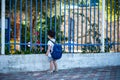 Child with bag back to school. Faceless cute little boy back to school with blue schoolbag.