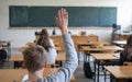 Kid school student raising hand at classroom Royalty Free Stock Photo