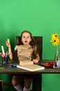 Kid and school supplies on green wall background Royalty Free Stock Photo