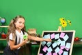 Kid and school supplies on green wall background Royalty Free Stock Photo