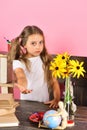 Kid and school supplies on pink wall background Royalty Free Stock Photo