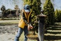 Kid schoolboy in casual clothing washing his hands in the street old fashioned drinking water fountain. Boy in blue Royalty Free Stock Photo