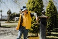 Kid schoolboy in casual clothing washing his hands in the street old fashioned drinking water fountain. Boy in blue Royalty Free Stock Photo