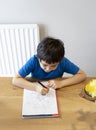 Kid in Self isolation doing his mathematics homework while school off, Child boy learning math at home during covid lock down,Home Royalty Free Stock Photo