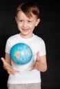 Kid in Self isolation looking at globe learning about Covid-19 Coronavirus from home, Child with curious face thinking Royalty Free Stock Photo