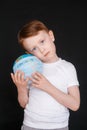 Kid in Self isolation looking at globe learning about Covid-19 Coronavirus from home, Child with curious face thinking Royalty Free Stock Photo