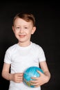 Kid in Self isolation looking at globe learning about Covid-19 Coronavirus from home, Child with curious face thinking about the Royalty Free Stock Photo