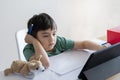 Kid self isolation using computor for his homework,Child using laptop searching information on internet while school off during Royalty Free Stock Photo