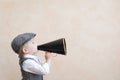 Kid shouting through vintage megaphone