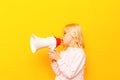 Kid shouting through vintage megaphone. Communication concept. Blue sky background as copy space for your text Royalty Free Stock Photo