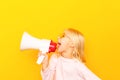 Kid shouting through vintage megaphone. Communication concept. Blue sky background as copy space for your text Royalty Free Stock Photo