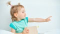 Kid shows a finger to the side on a white background Royalty Free Stock Photo