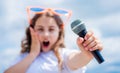 kid sing with mic. selective focus. cheerful event manager. child have fun on party. happy singer with microphone