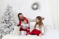 Happy dad found gifts near the Christmas tree with the children on morning Royalty Free Stock Photo