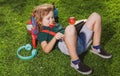 Kid sitting on grass with tablet in the park. Outdoor school. Smiling boy hold tablet computer. School, education Royalty Free Stock Photo