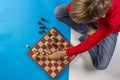 Kid sitting near chessboard and play chess game Royalty Free Stock Photo