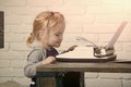 Kid sitting at table and typing typewriter with paper Royalty Free Stock Photo