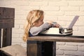 Kid sitting at table and typing typewriter with paper Royalty Free Stock Photo