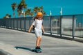 Kid skating on skateboard. Kid skateboarder ride a skateboard on street. Child in a summer city. Little child, toddler