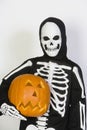 Kid In Skeleton Costume Holding Jack-O-Lantern