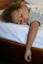 Kid sleeping on bed Royalty Free Stock Photo