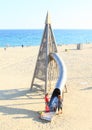 Kid on slide on beach Royalty Free Stock Photo