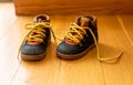 Baby shoes on wood, closeup view, child booties blue and yellow color Royalty Free Stock Photo