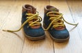 Baby shoes on wood, closeup view, child booties blue and yellow color Royalty Free Stock Photo