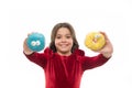 Kid smiling girl ready to bite donut. Sweets shop and bakery concept. Kids huge fans of baked donuts. Can you resist