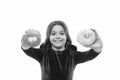 Kid smiling girl ready to bite donut. Sweets shop and bakery concept. Kids huge fans of baked donuts. Can you resist