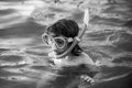 Kid snorkeling in ocean. Diving concept. Child dives into the water. Extreme sport. Kids summer holidays.