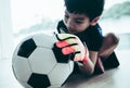 Kid soccer goalkeeper hand catching a football closed up shot