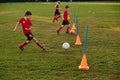 Kid soccer player in sport uniform training dribble ball, prepare to match on football field in motion. Playing Royalty Free Stock Photo
