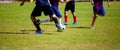 Kid soccer players run to trap and control the ball for shoot to