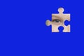 Kid spies through a blue puzzle. Symbol of autism awareness Royalty Free Stock Photo