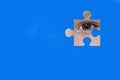 Kid spies through a blue puzzle. Symbol of autism awareness Royalty Free Stock Photo