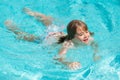 Kid splashing in summer water pool. Kid splash in swim pool. Excited happy little boy jumping in pool, water fun. Kid Royalty Free Stock Photo