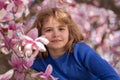 Kid in spring cherry blossom park. Happy childhood. Spring holidays. Adorable boy in spring garden. Cute little kid boy Royalty Free Stock Photo