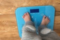 Kid standing on electronic scale barefoot Royalty Free Stock Photo