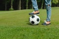 Kid standing with soccer ball on green meadow Royalty Free Stock Photo