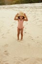Kid In Straw Hat On Beach. Tanned Little Girl In Swimsuit Having Fun. Cute Child In Swimsuit With Curly Hair. Royalty Free Stock Photo