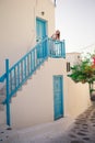 Kid at street of typical greek traditional village with white walls and colorful doors on Mykonos Island Royalty Free Stock Photo