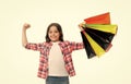 Kid strong makes independent purchases. Girl carries shopping bags isolated on white background. Girl fond of shopping Royalty Free Stock Photo