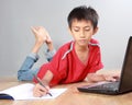 Kid studying with books and laptop Royalty Free Stock Photo