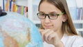 Kid Studying Earth Globe, Child in School Class, Girl Learning in Classroom, Student, Schoolgirl in Library Royalty Free Stock Photo