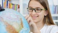 Kid Studying Earth Globe, Child in School Class, Girl Learning in Classroom, Student, Schoolgirl in Library Royalty Free Stock Photo