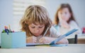 Kid studying at school. Schoolchild doing homework at classroom. Education for kids. Royalty Free Stock Photo